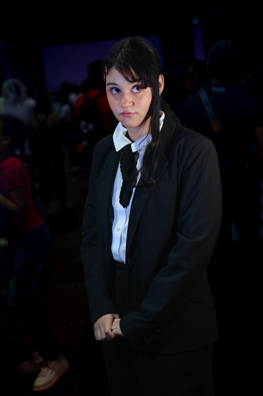 Portrait of a smiling woman in a blazer at a conference